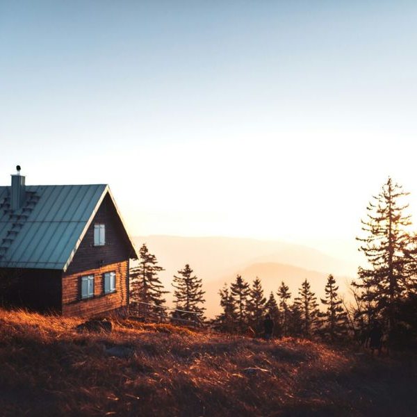 Cabin on a hillside at sunset